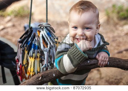 Child of rock climbers smiling while standing