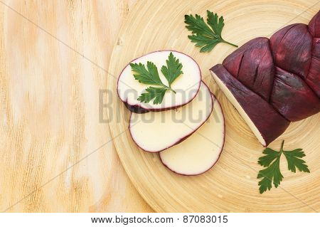 Treccia Braided Mozzarella Marinated In Red Wine On Wooden Cutting Board