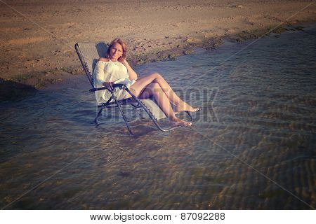 young woman in sexy swimsuit relaxing on the beach