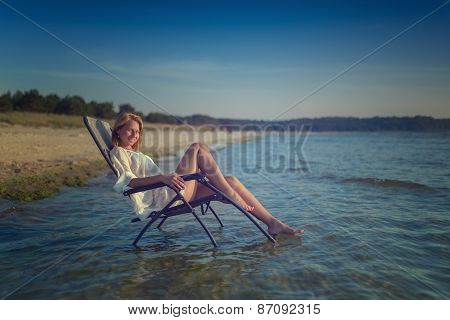 young woman in sexy swimsuit relaxing on the beach