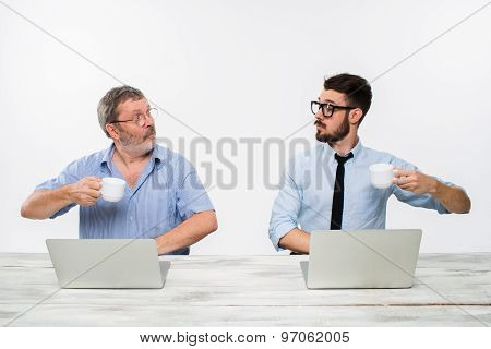 The two colleagues working together at office on white background