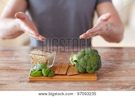 healthy eating, diet and people concept - close up of male hands showing food rich in fiber