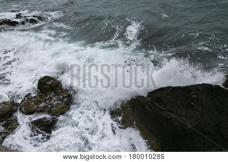 Rocks And Sea Shot On Cloudy Day