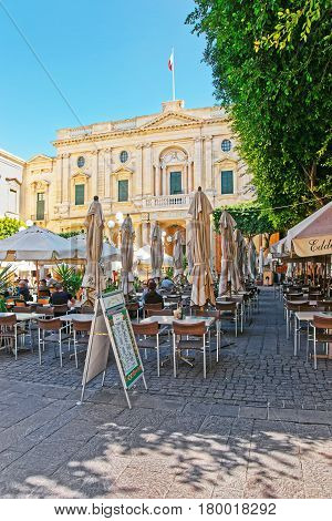People Resting In Open Air Cafes On Republic Square Valletta