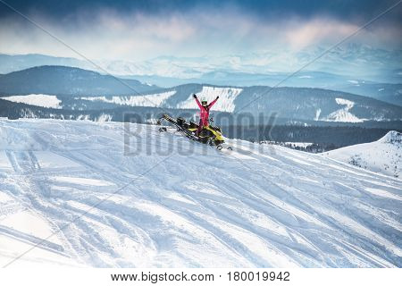 Rider on the snowmobile in the mountains ski resort in Amut Russia.