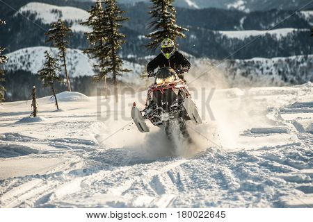 Rider on the snowmobile in the mountains ski resort in Amut Russia.