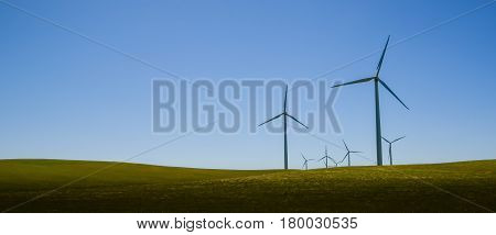 Wind turbines in wide open field of grass