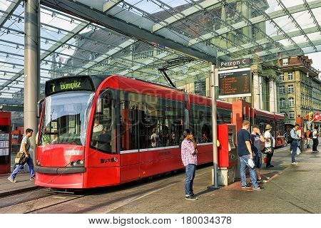 Tram And People At Train Station On Bahnhofplatz In Bern