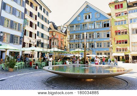 Fountain And People At Munsterhof Square Zurich