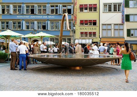 People And Fountain At Munsterhof Square In Zurich