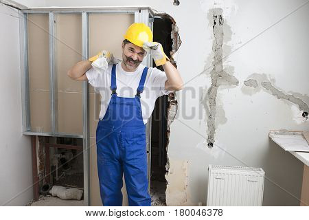 Happy Construction Worker Carrying Poly Bag  