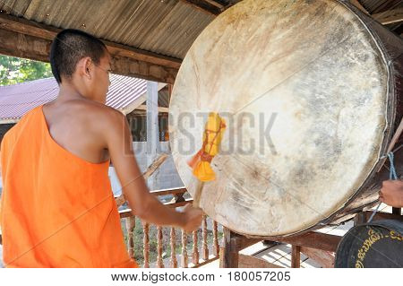 Buddhist Monk Playing Big Drum At Champasak On Laos