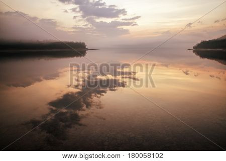 Sunrise on lake Liptovska Mara Slovakia. Mirror reflection on water