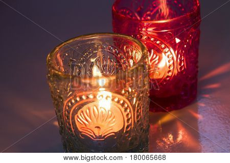 pink candle and light blue candle on a table .