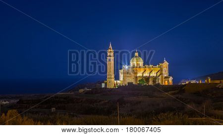 Gozo Malta - The Basilica of the National Shrine of the Blessed Ta' Pinu at night with clear starry sky on a summer night