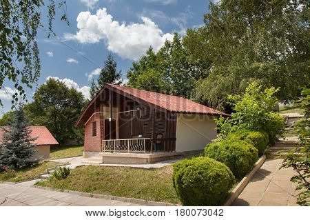 Wooden bungalows and garden in the forest. Holiday apartmens
