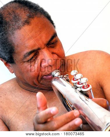African american jazz musician blowing his flugelhorn.