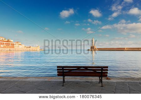 venetian marina of Chania with bench and lighthouse at sunny day, Chania Crete, Greece