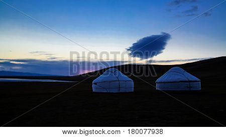Cloud over the yurts at the shore of Song Kol Lake at the dawn Kyrgyzstan