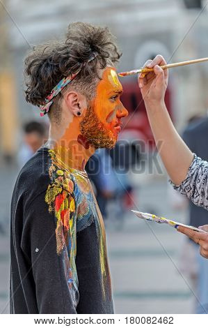 TIMISOARA ROMANIA - MARCH 31 2017: Face and body painting of a man. 3D art symbolizing on live at the street inside the CheckART Carnival organized by the City Hall Timisoara. Liberty Square.