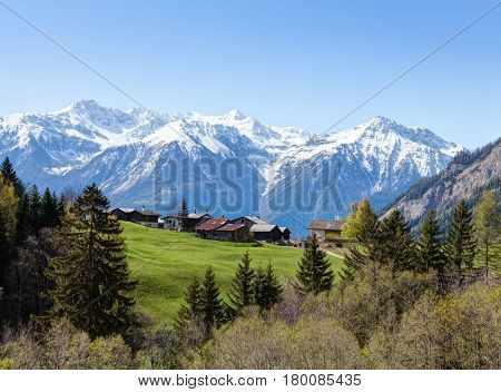 Small farm at   early spring  morning  in Swiss alps (near Leukerbad).  Bodmen, Valais, Switzerland.