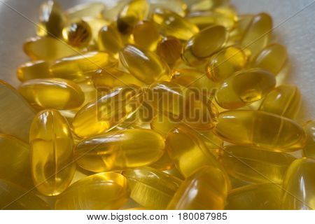 Pile of evening primrose oil supplement capsules