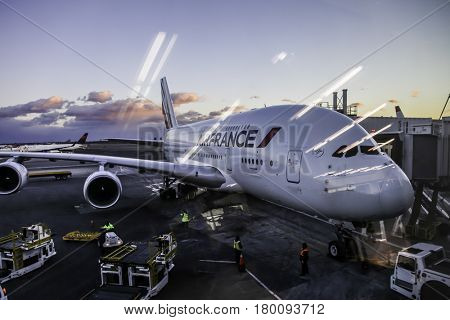 NEW YORK - DECEMBER 15: JFK International Airport sunsett with Airfrance Airbus A380 airplane on front, seen in Long Island, New York on December 15, 2016