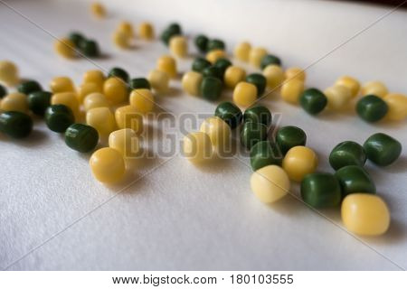 Lots of small yellow and green candy drops