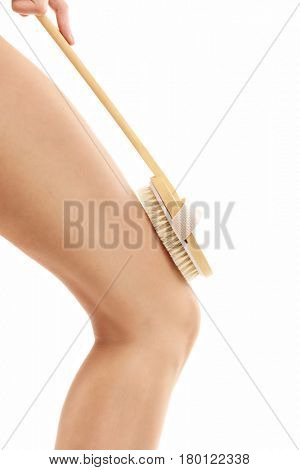 Woman legs with bath sponge isolated on white with healthy skin