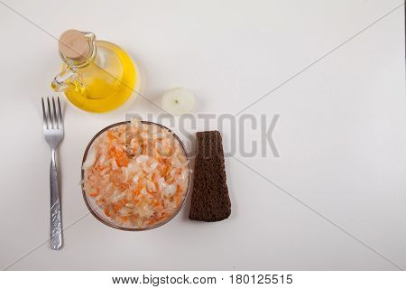 Sour Cabbage On A Plate, Vegetable Oil And Black Bread On A White Background