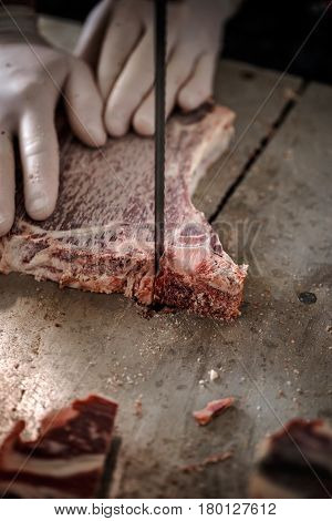 Male Butcher's Hand Slicing Meat
