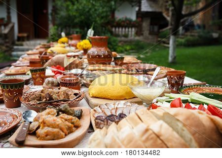 table with homemade moldavian food in clay dishes