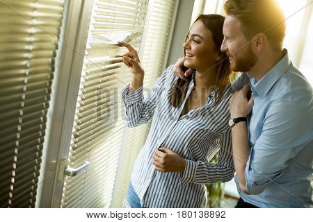 Attractive Couple Looking Trough The Room Window
