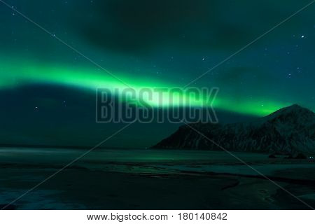 Aurora Borealis Known as Nother Lights Playing with Vivid Colors Over Lofoten Islands in Norway. Horizontal Image Orientation