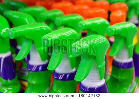 Close up of colorful spray bottles with cleaning agents in supermarket