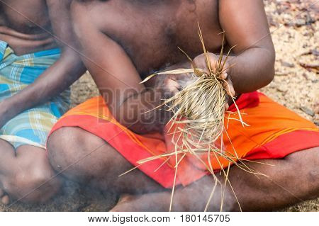 DABANA, SRI LANKA - CIRCA DECEMBER 2016: Vedda men making fire. Veddas are an indigenous people of Sri Lanka living in tribes in the jungle