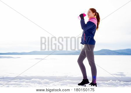 Sporty girl drinking water after workout. Healthy diet concept