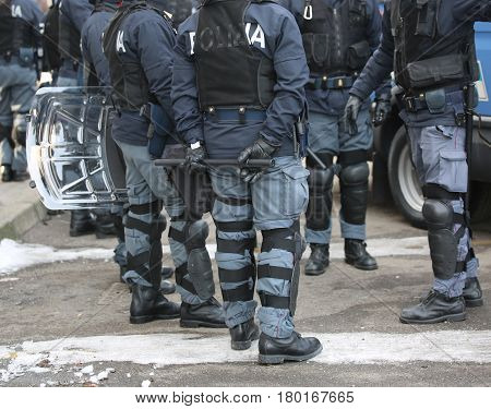 group of police with shields and riot gear during the sporting event in town