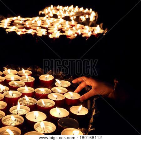hand of the person who lights a candle during the religious ceremony
