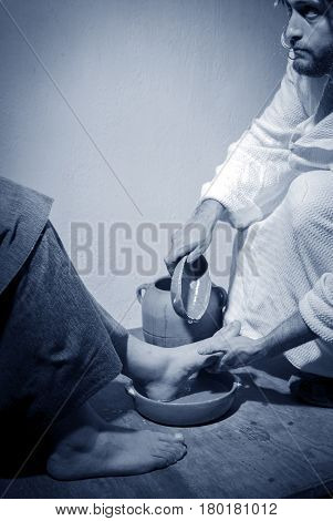 Jesus Christ washing the feet of his apostles in a sign of service and humility