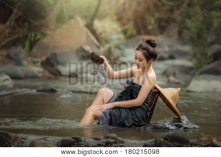 Women in the shower in nature creek forest enjoy on the river relax