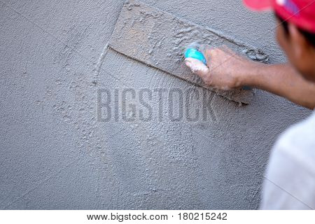 Man worker Plastering concrete with the wall and The building with concrete for house construction.