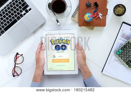 CHIANGMAI THAILAND -FEB 052017:Man hand holding ipad 4 with busy page of popular app Pokemon Go