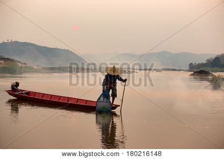 AsianThailand fisherman cacth fish on the wooden boath in mekong river