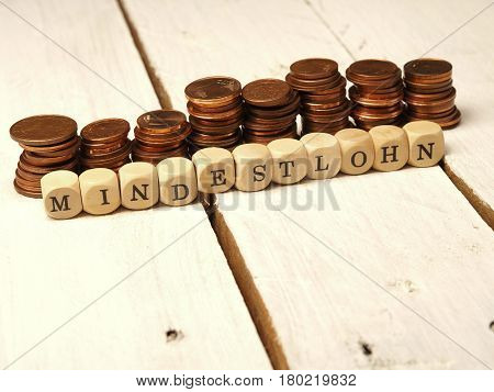 German concept image wtih the words minimum wage on dices