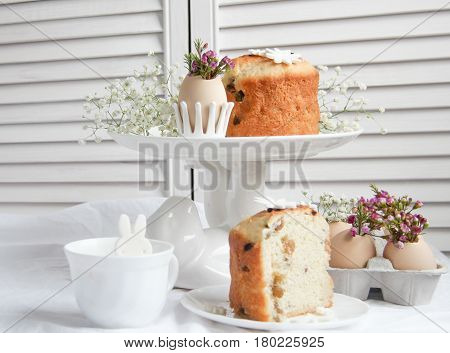 Easter cake in the form of the Easter Bunny and Easter decor with flowers on the table