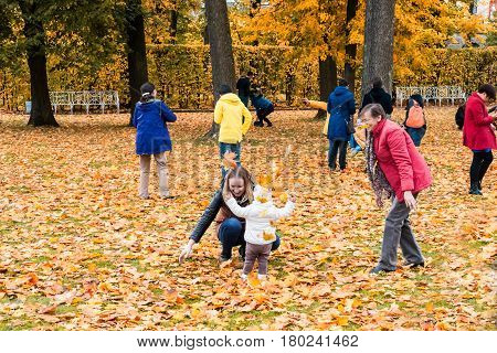 ST. PETERSBURG RUSSIA - OCTOBER 02: People play in the Indian summer in Pushkin RUSSIA - OCTOBER 02 2016. In suburbs of St. Petersburg in parks very beautiful fall.