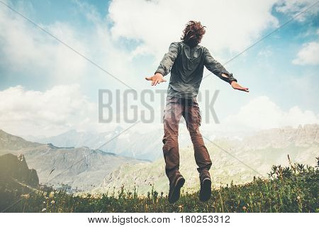 Man jumping up at mountains to clouds sky Lifestyle Travel emotional euphoria success concept adventure summer vacations outdoor