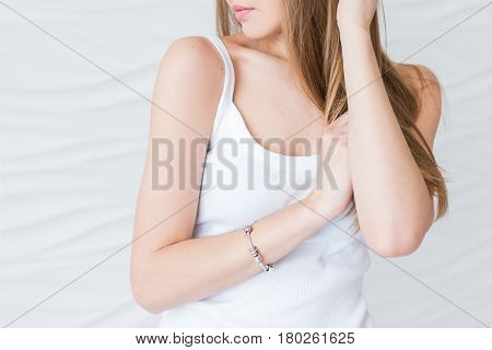 Caucasian young model with brown hair in white singlet. Sexy closeup portrait noface only lips