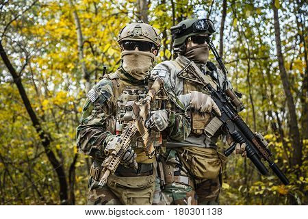 Two United states Marine Corps special operations command Marine Special Operators also known as Marsoc raiders in camouflage uniforms in the forest